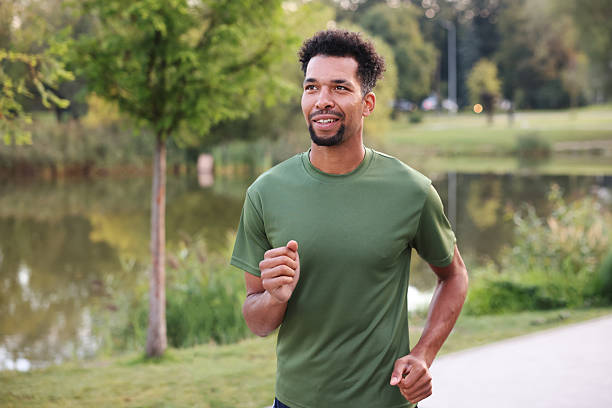 istock Smiling man running near river outdoors. Healthy lifestyle 2249763747