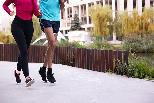 istock Couple in sportswear running outdoors, closeup. Space for text 2249763749