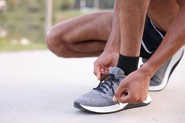 istock Runner tying shoelace of his sneaker outdoors, closeup. Space for text 2249764411
