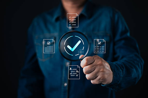 istock person hold magnifying glass with glowing checkmark surrounded by digital documents and AI icon representing verification,approval,document review,compliance,accuracy,and digital validation processes. 2249764420