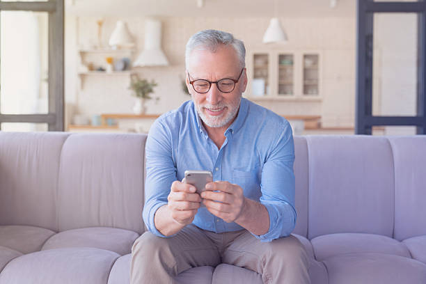 istock Happy confident senior old mature elderly man grandfather using smart phone, searching web, loading feed, social media. Communication with children, grandchildren on retired 2249765283