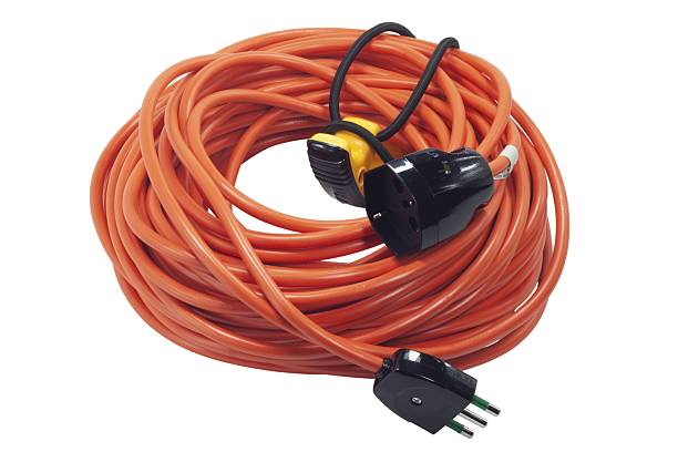 istock Orange coiled extension cord with electric plugs on white 2249765671