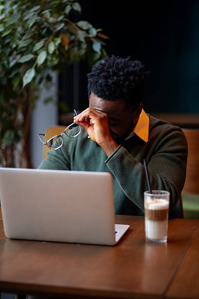 istock Young man rubbing eyes from headache 2249766133