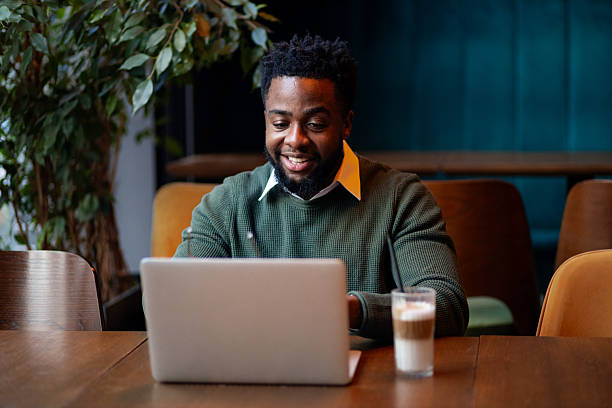 istock Young man happily reviewing work online 2249766181