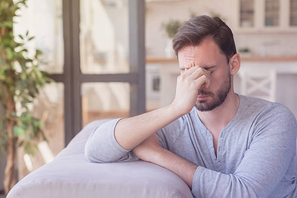 istock Tired stressed sad bored young caucasian man relaxing after work, family relationship problems, emotional stress, depression. Negative emotions concept resting sit a sofa 2249767112
