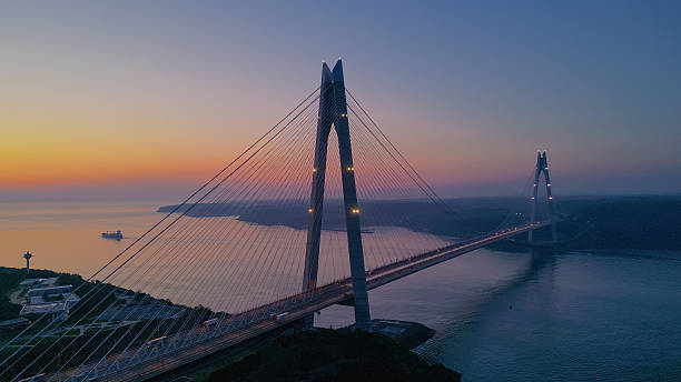 istock Sunset in Istanbul Turkiye: Cargo Ship Passing under Yavuz Sultan Selim Bridge at Sunrise 2249768593