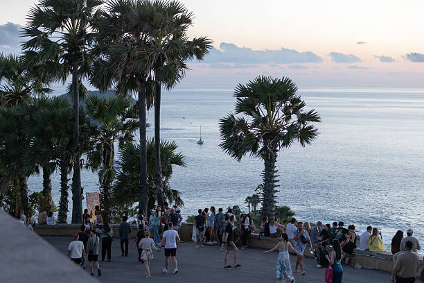 02 December 2025, Phuket Island - Thailand.Tourists gather at the Promthep Cape viewpoint in Phuket as the sun sets over the Andaman Sea. Known as a major tourist landmark, Promthep Cape attracts large numbers of visitors daily due to its panoramic scenery and status as a signature viewpoint of the island.