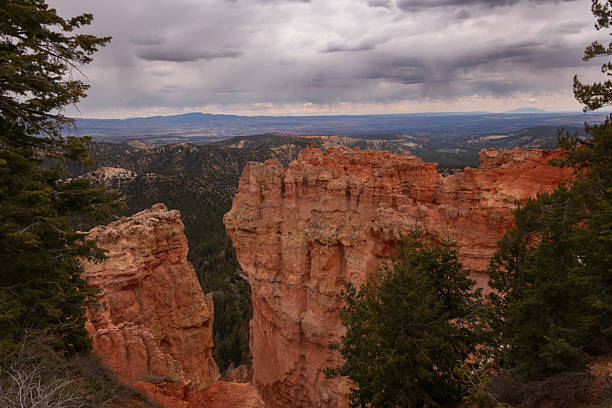 Agua Canyon is a viewpoint located on the scenic drive in Bryce Canyon National Park. It offers stunning views of coral-colored hoodoos, formed by erosion. The canyon is also home to two prominent hoodoos: The Hunter, which is the taller of the two towers on the left, and the Rabbit on the right.