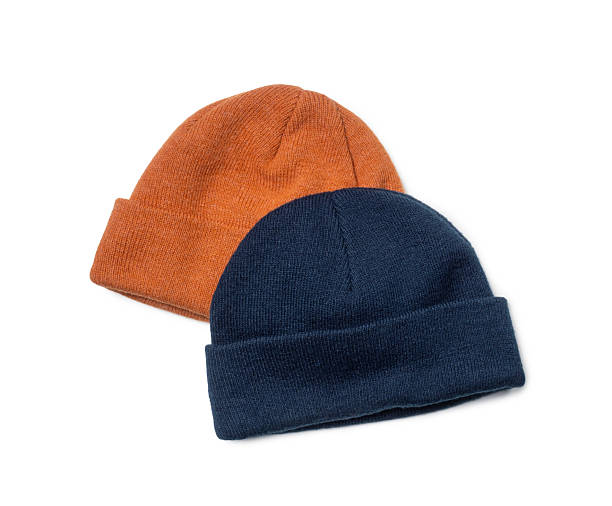 istock Orange and blue warm woolen hats close-up on white background 2249772816