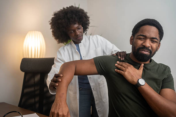istock Young Man with Shoulder Pain in Physiotherapy Consultation. 2249774478