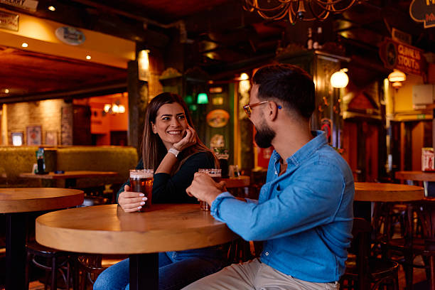 istock Couple enjoying beer dating in a cozy pub setting 2249784472
