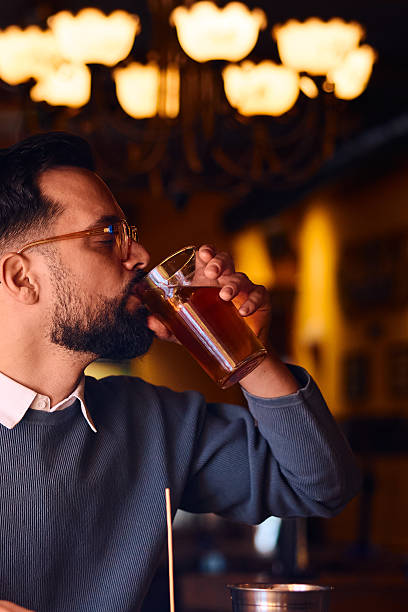istock Adult man drinking refreshing beverage in pub 2249785280