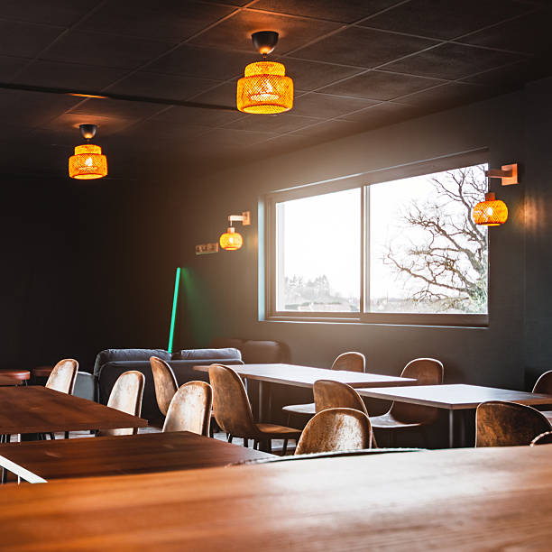 istock Empty wooden bar counter and dining area illuminated by warm sunlight inside a modern microbrewery in France 2249785766