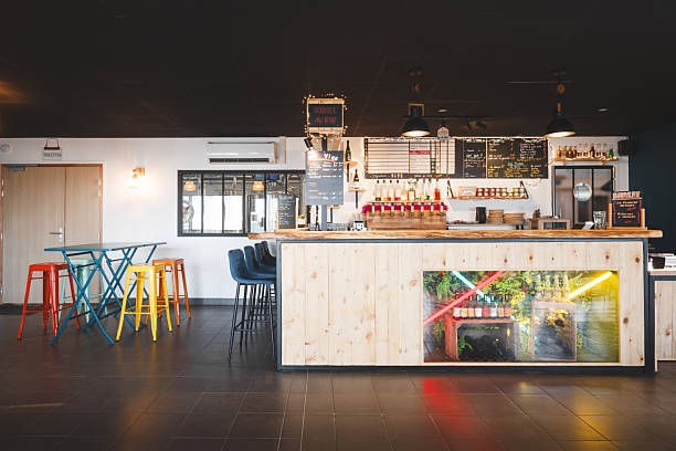 istock Modern wooden bar counter and colorful metal stools inside an empty microbrewery interior in France 2249785806