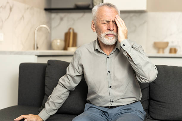 istock Elderly man suffering from headache in living room during daytime 2249785834