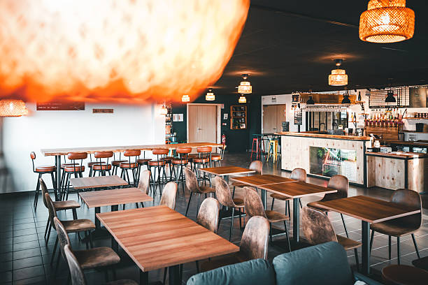 istock Empty wooden dining tables and bar counter in cozy craft microbrewery restaurant interior in France 2249785857