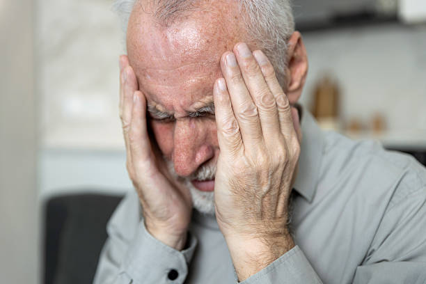 istock Older man suffering from severe headache in his home living room environment 2249786042