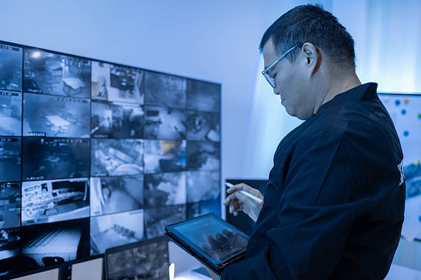 istock Security guard, woman and tablet with surveillance video, observation app and watching at night. Working in Control room by cctv monitor for protection, data center or building safety. Inspection, video surveillance agency and control room with footage 2249789770