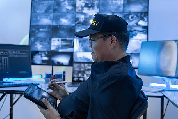 istock Security guard, woman and tablet with surveillance video, observation app and watching at night. Working in Control room by cctv monitor for protection, data center or building safety. Inspection, video surveillance agency and control room with footage 2249789903