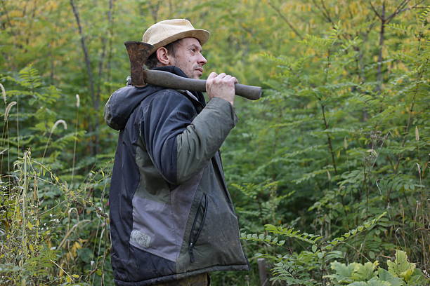 countryside wood working man using ax hatchet at own home garden