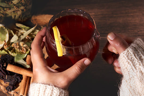 Hand Holding A Cup Of Herbal Tea