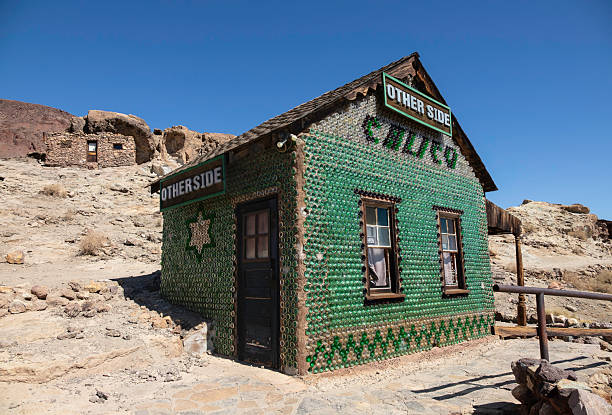 The walls of the Bottle House, originally a tavern frequented by silver miners, are constructed entirely of glass bottles cemented together in rows. Pictured here in October 2022, it is now an historic landmark at Calico Ghost Town in San Bernardino County, California. The once-prosperous town, now a part of the county’s  Regional Park system, was abandoned in the mid-1890s when silver prices collapsed.