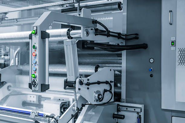istock Automatic polyethylene plastic bag production machint. Close-up of the roller of plastic bag production machine in the light blue scene. product packaging concept 2249796583