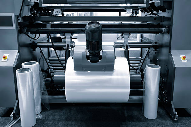 istock Automatic polyethylene plastic bag production machint. Close-up of the roller of plastic bag production machine in the light blue scene. product packaging concept 2249797074