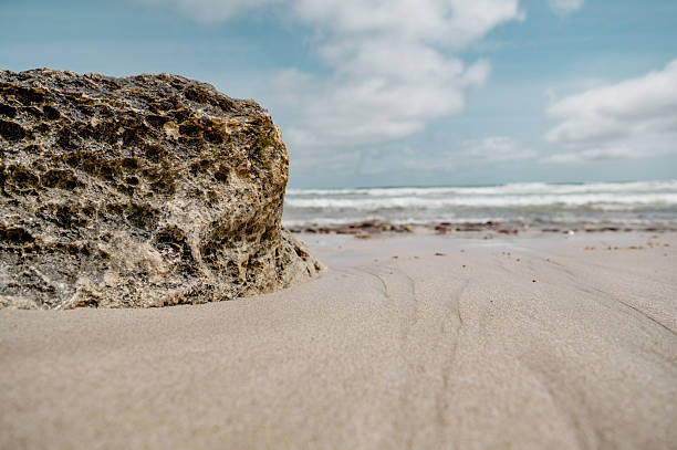 istock Close-up of a rock on a deserted beach 2249799902
