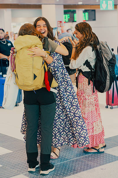 istock Friends hugging at airport reunion expressing joy and happiness 2249802465