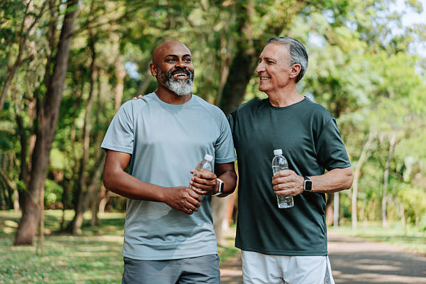 istock Senior friends walking in public park 2249804148