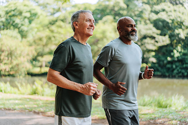istock Senior friends walking in public park 2249804189