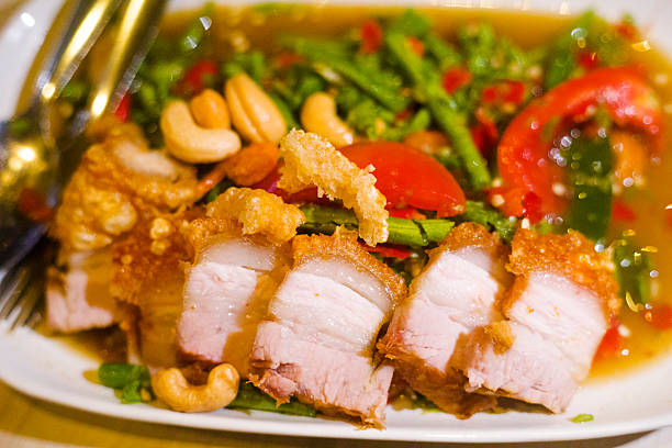 Close-up of Crispy thai pork belly with nuts