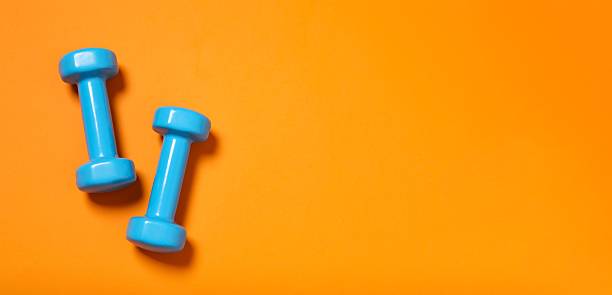 istock Sports dumbbells on a colored background 2249811408