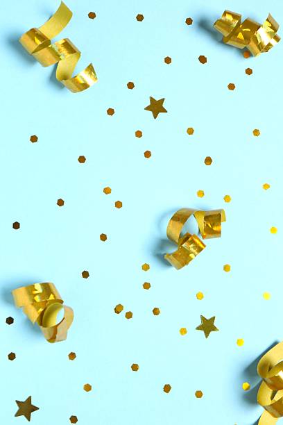 istock Vertical view of golden confetti on blue background 2249812943