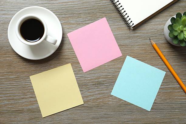 Workplace with stickers, glasses and coffee cup, top view