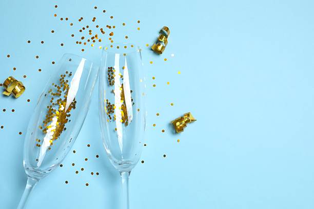 istock Festive background with champagne glasses and confetti 2249814120
