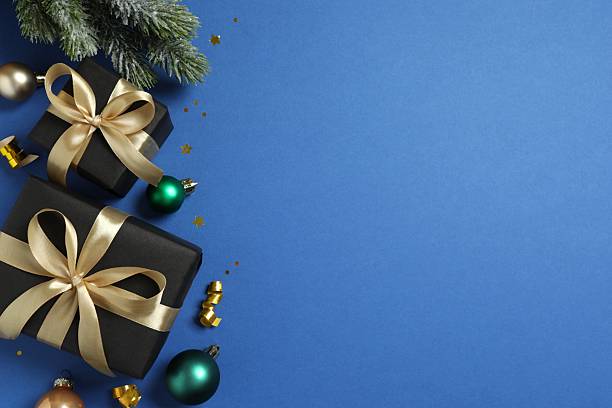 istock Flat lay composition with gift boxes tied with bows and decorations on color background 2249814530