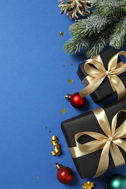 istock Vertical view of gift box and ornaments on blue background with empty space. Christmas concept. 2249814538