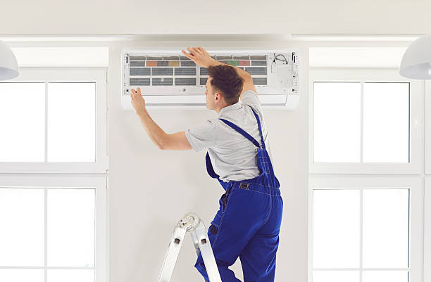 istock Worker Inspecting Air Conditioner At Home Using Instrument For Repair 2249814885