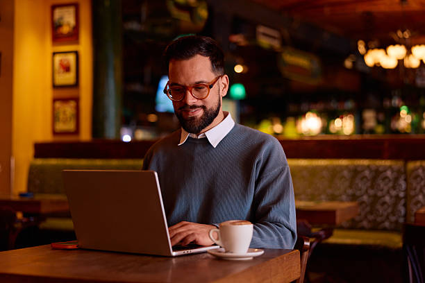 istock Man working remotely on laptop in cafe 2249815890