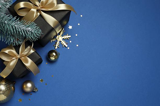istock Close-up view of gift boxes and ornaments on blue background with empty space. Christmas concept. 2249816917