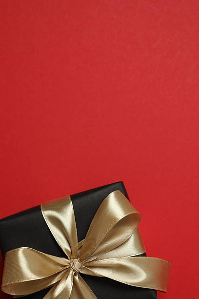 Vertical view of beautiful gift box on red background