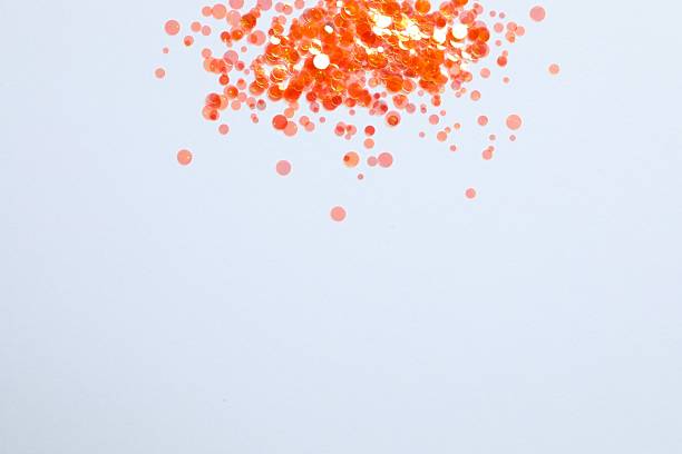 istock Shiny orange confetti on a white background 2249818605