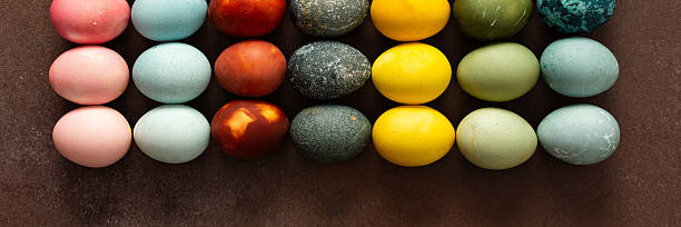 istock Brightly colored Easter eggs are arranged in a grid, displaying shades like pink, blue, green, and yellow. These eggs symbolize renewal and are often part of festive gatherings, banner 2249819501