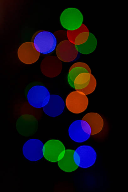 istock Colorful bokeh lights in abstract blurred circles on a dark background 2249822336