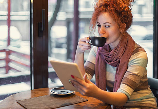 istock Woman sitting in a cafe and using a digital tablet 2249822734