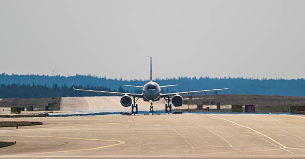 istock Airliner approaching along long runway under hazy sky conditions. 2249824615