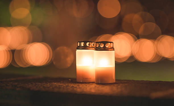 istock Glowing memorial candles illuminating dark night atmosphere. 2249825089