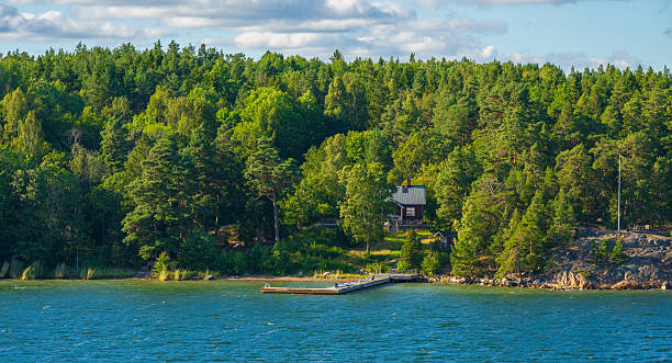 istock Scenic coastal cabin surrounded by lush forest and calm waters. 2249825242